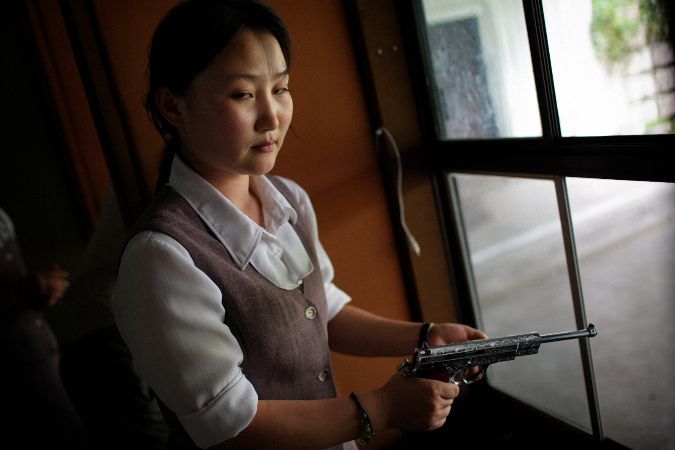 Tomas van Houtryve, A North Korean woman loads a pistol for firing practice in Pyongyang, North Korea, 2007