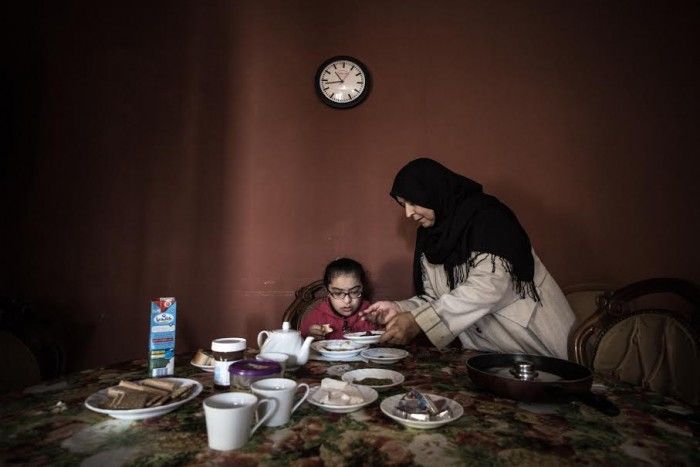 © Mohamed Alalem, for Reporting Change. Shahd. Shahd’s mother serves her breakfast, at home in Tripoli. 