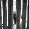 Juozas Cernius - London, Ontario, Canada - Young girl peers into a thatch hut in Ecuador's Amazon region, 2012.