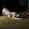 Anna Boyiazis - Los Angeles, California -  UGANDA. Rakai. 2006. Molly, 14, playing a game with dried fruit.