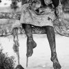 Anna Boyiazis - Los Angeles, California -  UGANDA. Rakai. 2006. Helen, 12, sitting in a tree. Her brother, Eddie, 8, swinging on a rope below her.