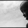 Benjamin Rusnak - Boca Raton, FL -  Hope Aloft.  A kite made of sticks and a plastic bag flies over a Cap Haitien, Haiti slum with the innocence and hope of the boy who made it from matierials he found in the garbage.