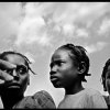 Benjamin Rusnak - Boca Raton, FL -  Waiting.  A trio of girls anxiously waits in line for food at a relief agency distribution near Port-au-Prince, Haiti.