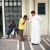 Paolo Morales - New York, NY - A priest and his assistant. Manila, Philippines. 2011