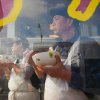 Jacob Yeung - Restaurant workers in Chicago's Chinatown, eating while observing the Chinese New Years Parade from kitchen