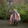 Serge Poliakov - woman selling ticker tape in front of a Christmas trees on the street