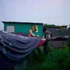 Emmanuel Serna - Ramesh a 35 years old Sri Lankan, in Hong Kong for 8 years, is on the phone at the window of his shack that he built by himself in a slum in Lam Tei. About 40 refugees live in this slum. Hong Kong, July 2015