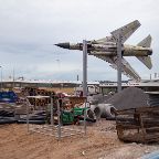 Erik Tham - Retired Supersonic Birds: A discarded Russian MIG-23 fighter jet is set up for display in the midst of a temporary construction site in front of the museum for technology in Sinsheim, Germany