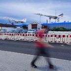 rik Tham - Retired Supersonic Birds: On his way home through the industrial area surrounding the museum for technology in Sinsheim, Germany, a man walks by the discarded Tupolev Tu-144 and Concorde supersonic passenger aircrafts, both visible in the darkening evening sky at the rooftop of the museum, behind a used-car dealer