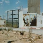 Michael Dietrich - Yasser Arafat and Mahmoud Abbas printed on a wall-mounted poster on a collapsed part of the Jericho Prison