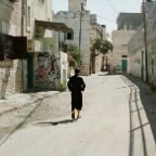 Michael Dietrich - Arab child walking through Aida, a Palestinian refugee camp adjacent to Bethlehem, established 1950