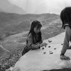 Sascha Richter - Girls are playing with stones on a self-made board