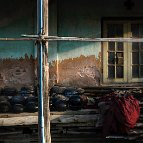 Blu Wirisi - Alm bowls are washed and dried in front of the study hall in an old monastery in Myanmar