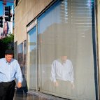 people on the street... Michael T. Sullivan - man walking beside his reflected self