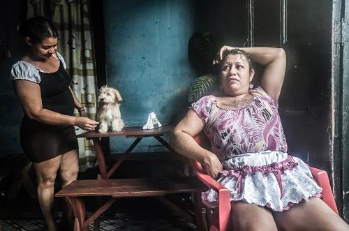 John Sevigny - A female prostitute (left) and a transexual prostitute at the bar and brothel where they live in San Salvador. 