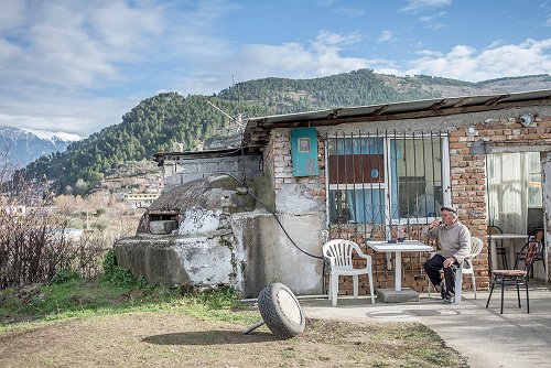 Oleksandr Rupeta - The owner of the cafe drinks wine in the backyard of his cafe, Berat, Albania