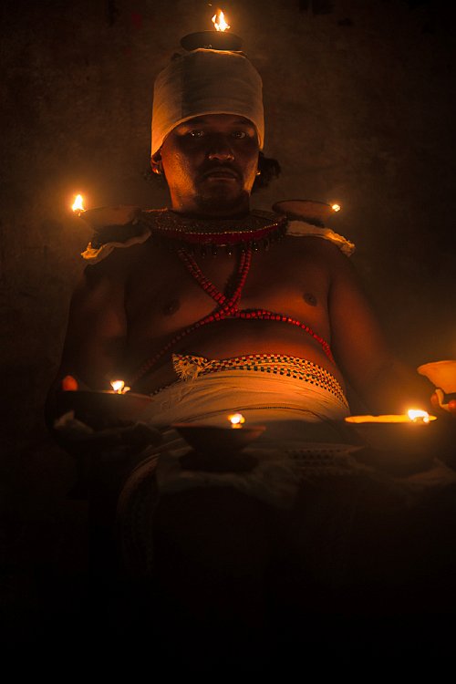 Mick Stetson - From sunset to sunrise, a devotee keeps a vigil, ensuring that the goddess Durga has light for fighting the evil that surrounds the city.